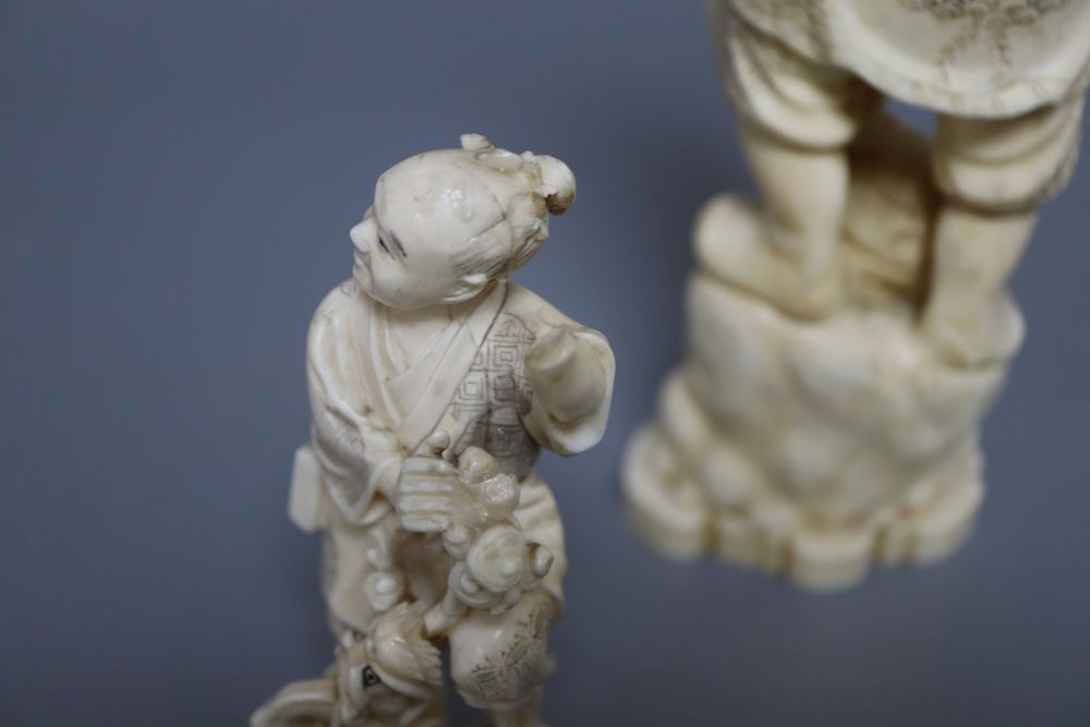 A Japanese ivory okimono of an elder and a dragon, and a marine ivory carving of Daikoku, tallest 25cm